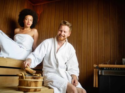 Happy couple having a steam bath in a sauna and relax